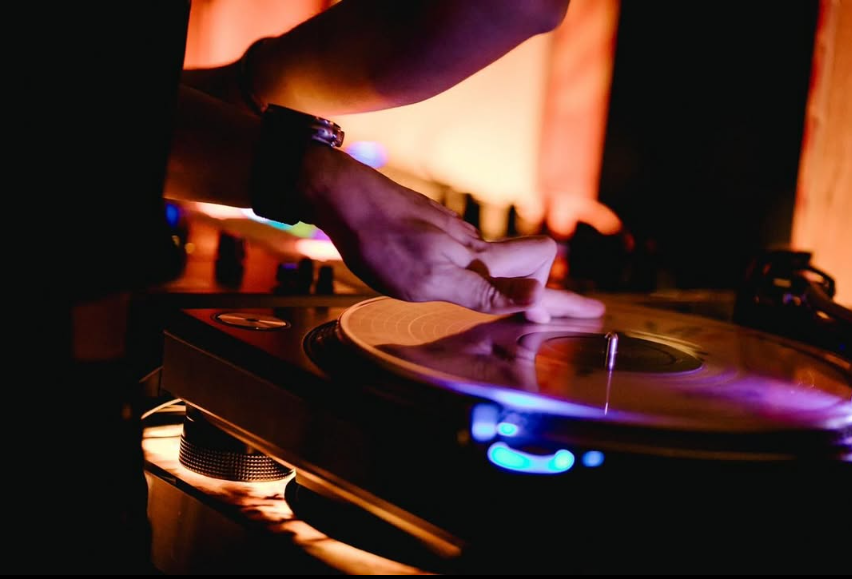 A DJ cueing a record during a late night at AMBER