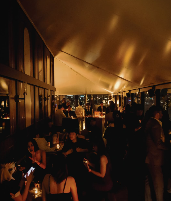 AMBER's warmly lit interior filled with guests after dark
